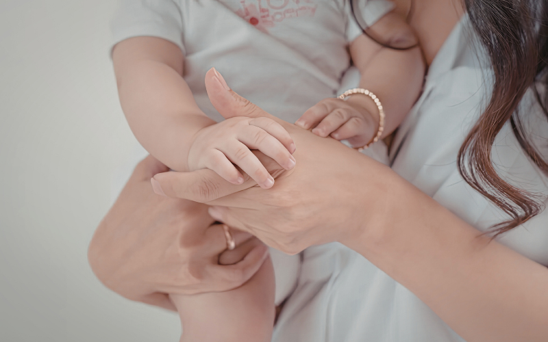 Éducatrice avec un bébé dans les bras.